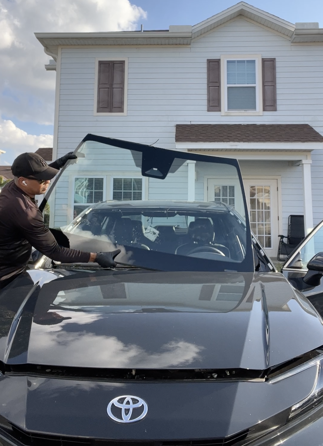 ViCars AutoGlass technician replacing windshield at customer home in Florida