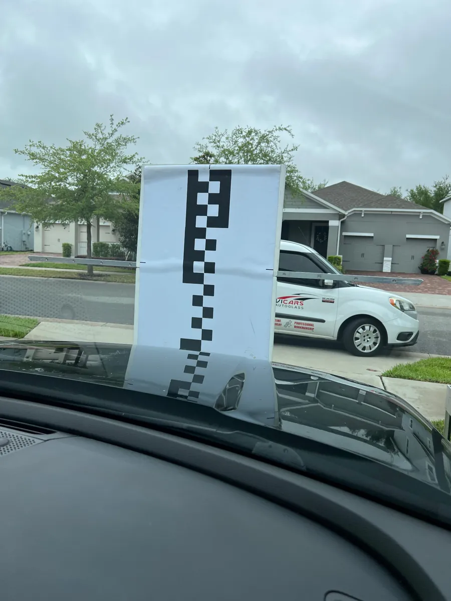 Static ADAS calibration target in front of a Kia Telluride after windshield replacement in Winter Garden, FL