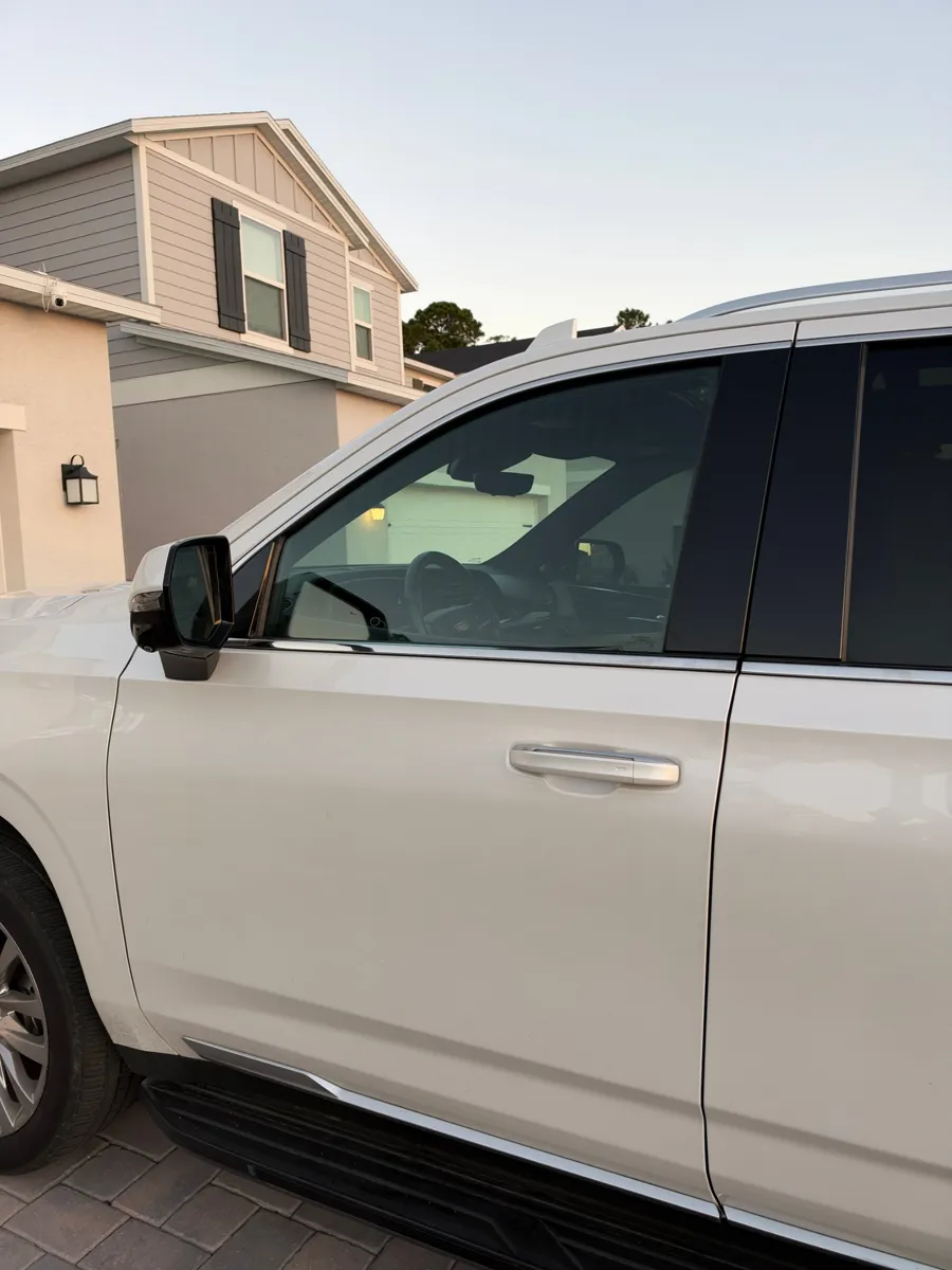 New front door glass with factory tint on a Cadillac Escalade in Clermont, FL