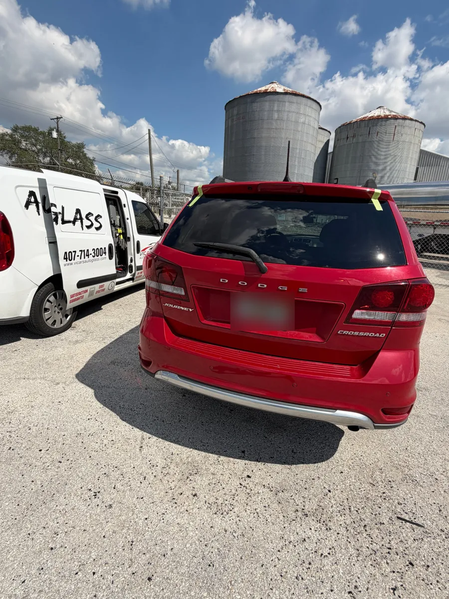 New back glass on a Dodge Journey next to the ViCars AutoGlass van