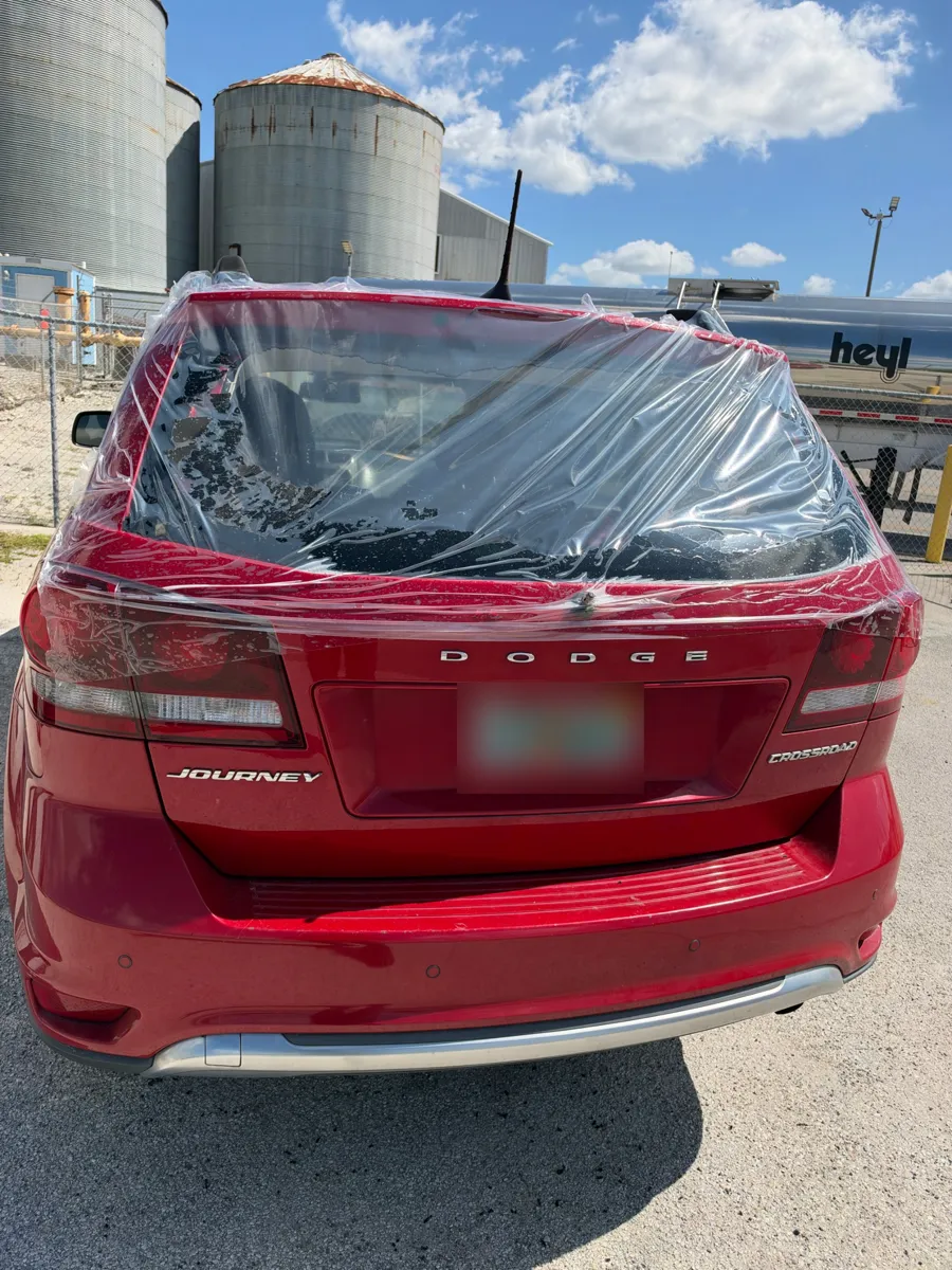 Broken back glass on a Dodge Journey covered with protective plastic in Lake Wales, FL