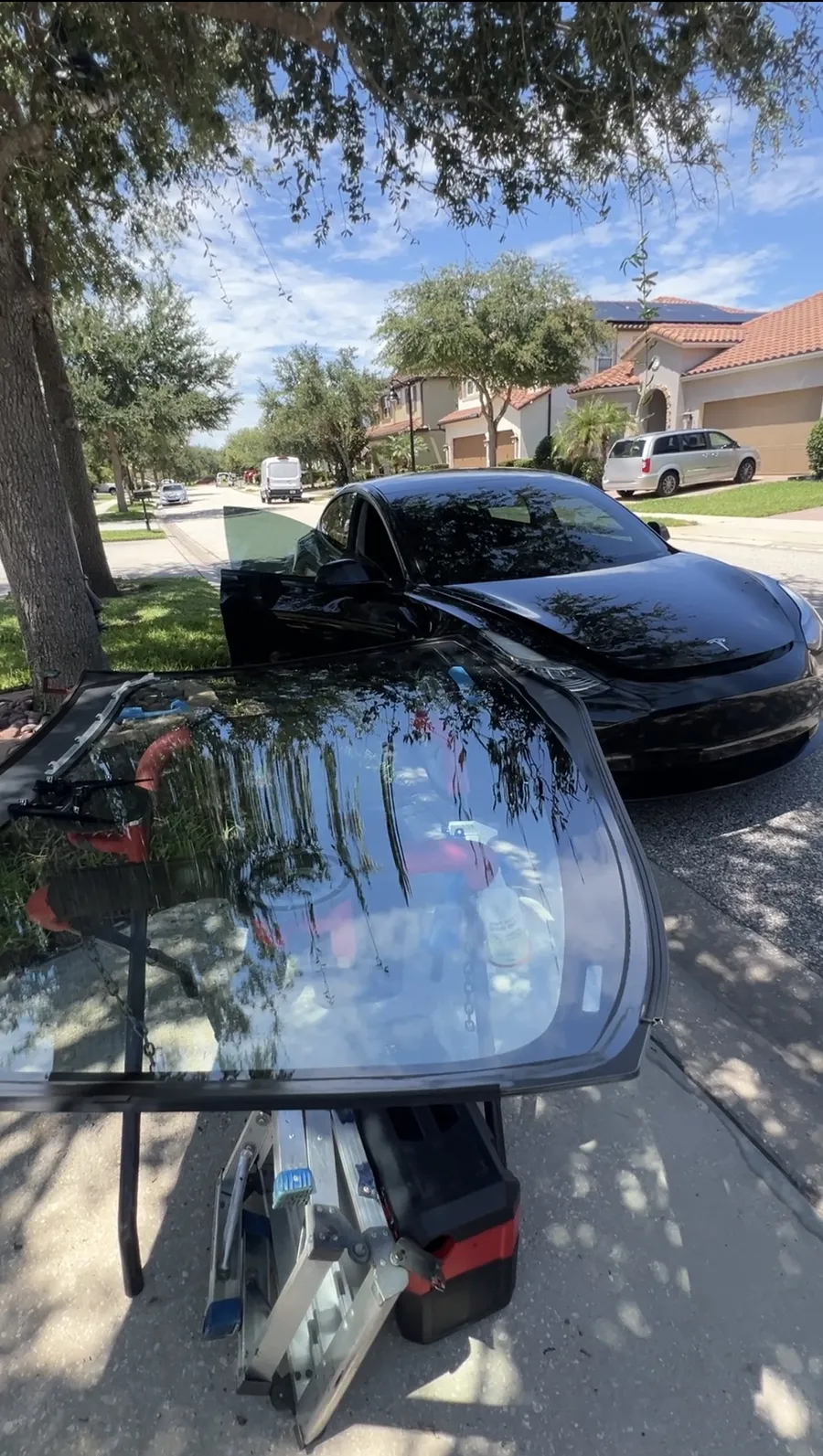 ViCars AutoGlass replacing the windshield of a Tesla Model 3 in Lake Nona, Orlando FL